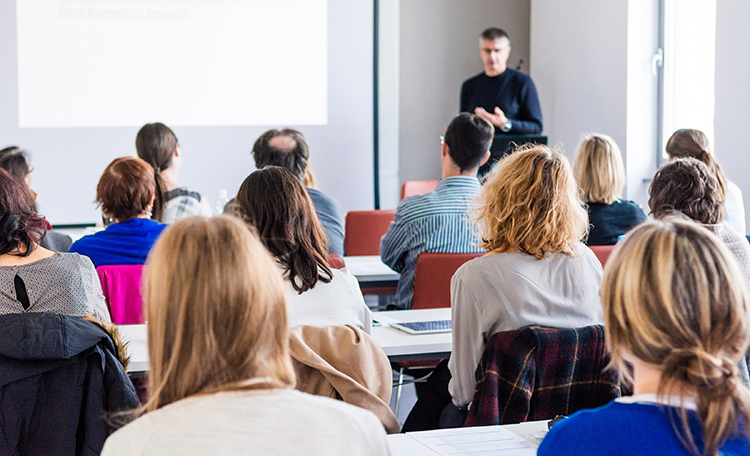 Person delivering a speach. Person delivering a speach. Audience at a conference presentation.