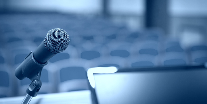 Rostrum with microphone and computer in conference hall