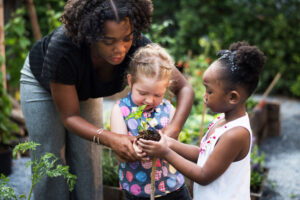 Teacher and children learning gardening