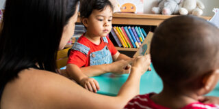 Young children learning the English alphabet with their parents
