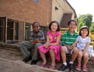 4 Children Sitting Outside