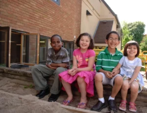 4 Children Sitting Outside