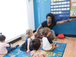 Woman and 4 kids on the floor